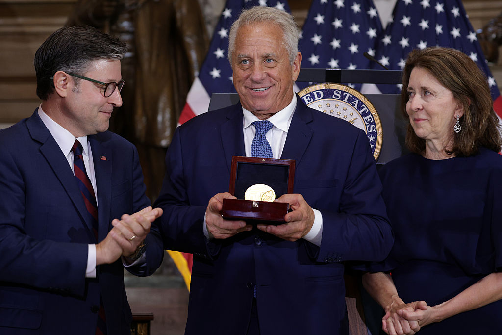 WASHINGTON, DC - JULY 09: U.S. Speaker of the House Rep. Mike Johnson (R-LA) (L) presents the Congressional Gold Medal to American road racing cyclist Greg LeMond (2nd L) as LeMond&#039;s family looks on during a Congressional Gold Medal ceremony at the Statuary Hall of the U.S. Capitol on July 9, 2025 in Washington, DC. LeMond, a two-time Road Race World Championship and a three-time Tour de France champion, was presented with the Congressional Gold Medal to honor his success. (Photo by Alex Wong/Getty Images)