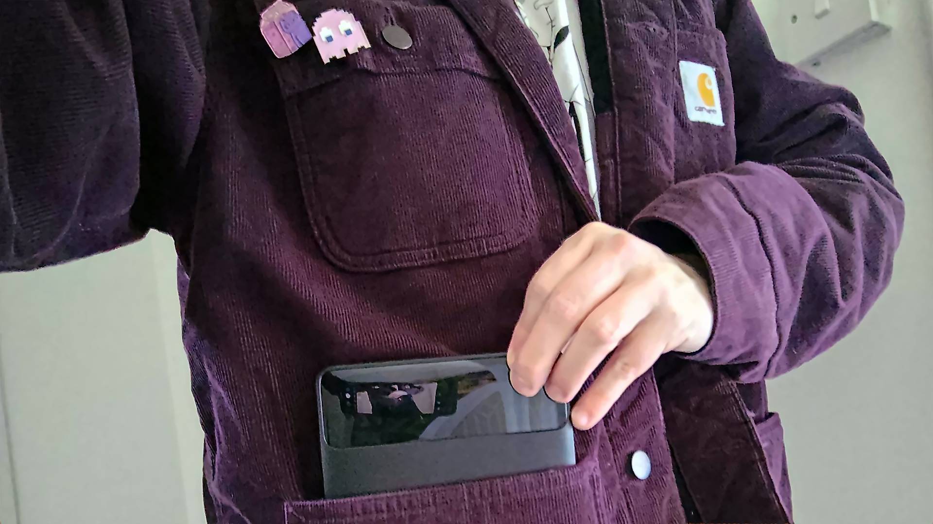 Phil wearing purple Carhartt jacket pulling Baseus Blade power bank out of pocket.
