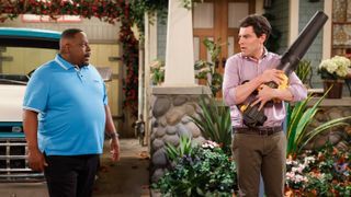 Cedric the Entertainer as Calvin and Max Greenfield as Dave outside in the front yard in The Neighborhood season 6