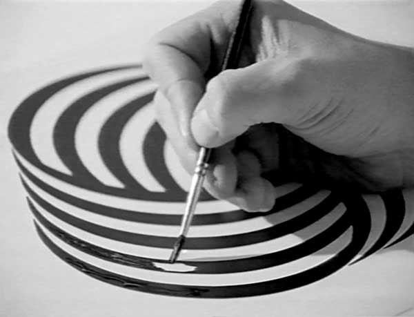 Image of someone painting lines of the Woolmark logo 