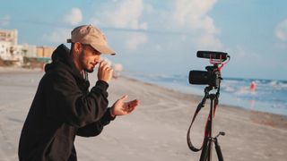 vlogger on beach using best cameras for vlogging