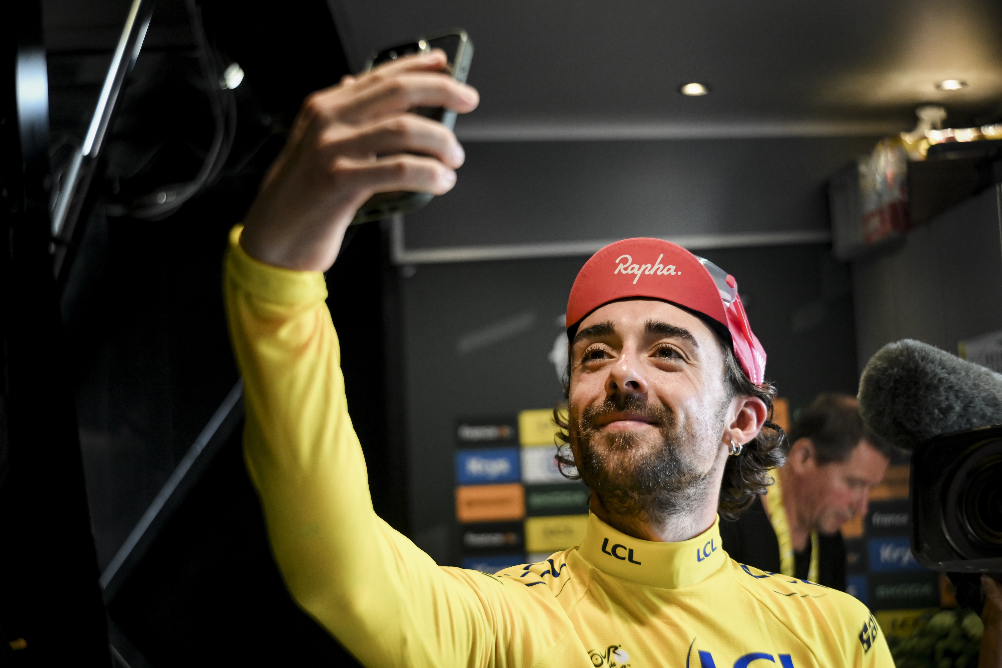 Ben Healy takes a selfie in the yellow jersey after stage 10 of the Tour de France.