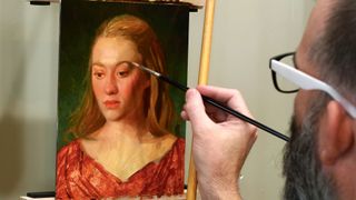 An artist painting a portrait in oils