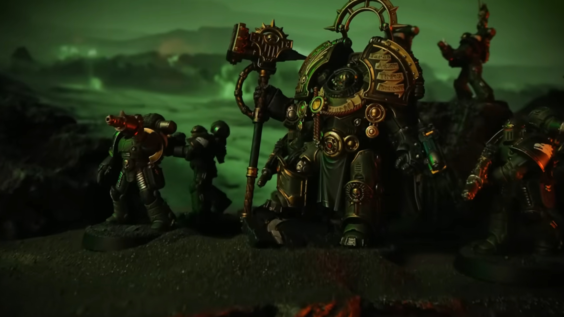 A Saturnine leader stands beside Space Marines on a green, alien landscape