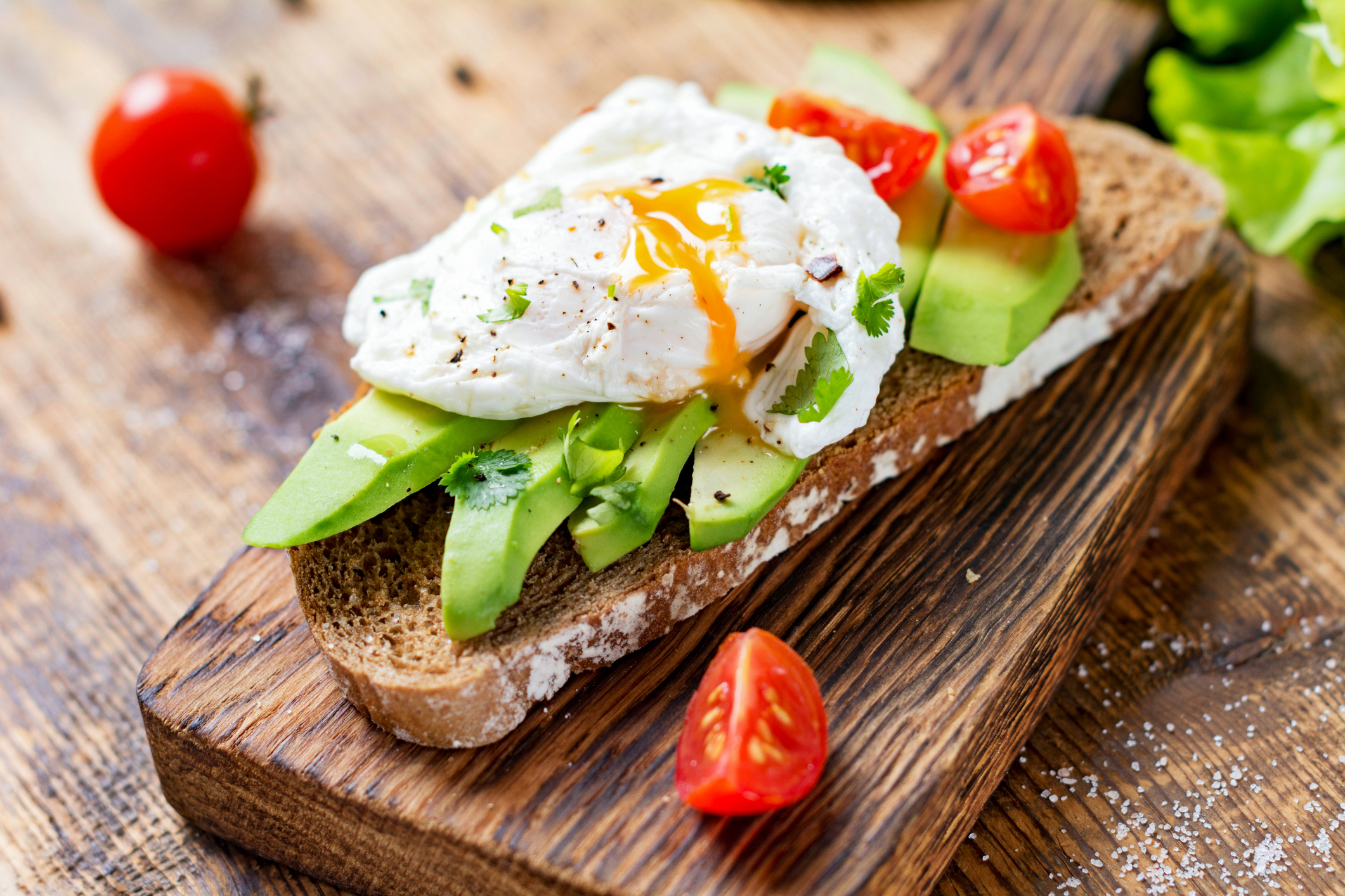 poached egg and tomatoes on avocado toast