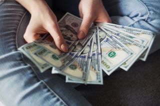 Freelance finance - Person holding dollar bills
