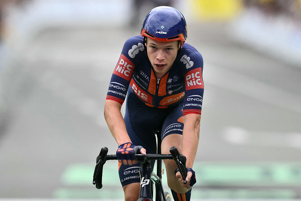 Team Picnic PostNL team's Dutch rider Frank Van Den Broek cycles to the finish line to place second in the 20th stage of the 112th edition of the Tour de France cycling race, 184.2 km between Nantua and Pontarlier, in the Jura, eastern France, on July 26, 2025. (Photo by Marco BERTORELLO / AFP)
