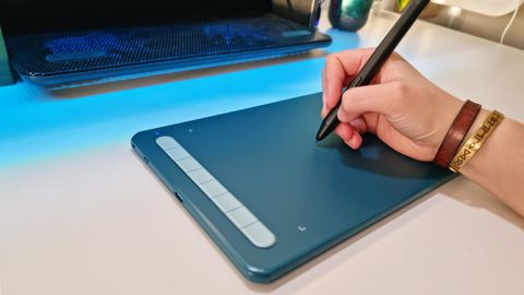 A shot of the XP-Pen Deco MW tablet in use on a white desk