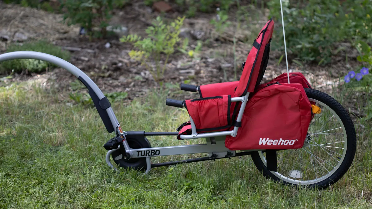 Side angle of the Weehoo Turbo Bike Trailer outside on the grass
