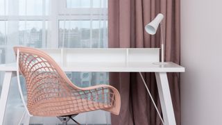 How to clean an office chair: a clean, neutral office chair in front of a white desk
