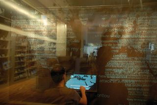 visitors tell their stories and respond to questions on the impact of 9/11 at the We remember storybooth in the 9/11 memorial museum