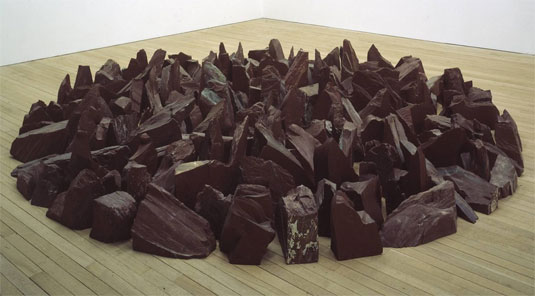 Richard Long, Red Slate Circle: "A group of people sit on the beach with two bags but also a group of people are on the beach with blankets. Reminds me of people on a beach, walking and laying on blankets."
