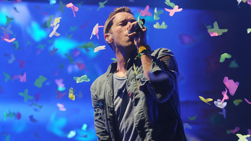 Chris Martin on stage at Glastonbury in 2011: he&#039;ll try to Fix You, but who&#039;s going to fix the mess being made by all that coloured ticker-tape?