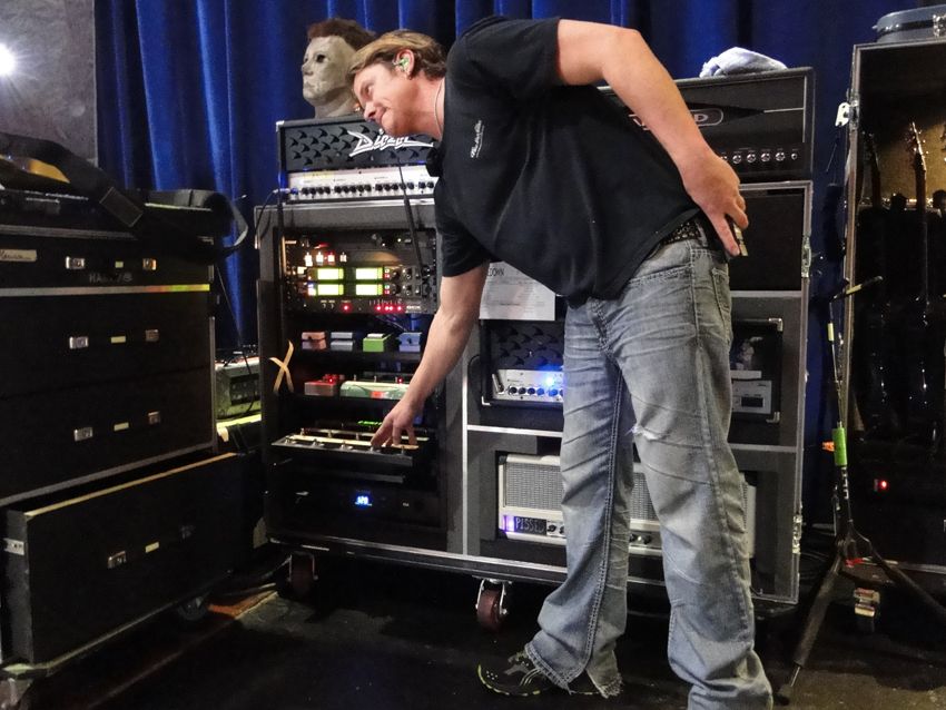 Myers' guitar tech, Sparky, tests an effect during soundcheck