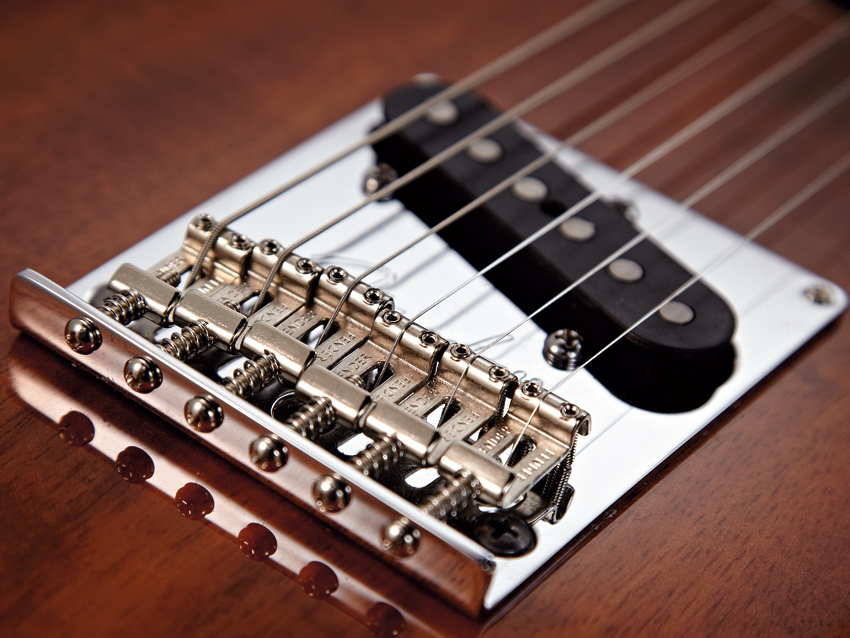 The Tele bridge has bent Strat saddles.