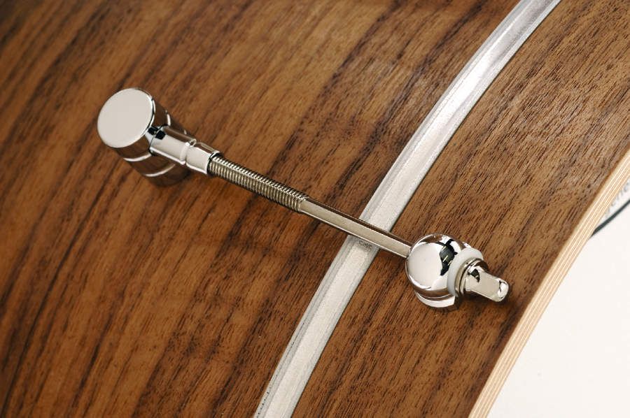 Tension bolts pass through each ear and into the lugs.