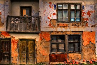 The ageing of this building is depcited through various colours of paint used over the years. Image © kamenf