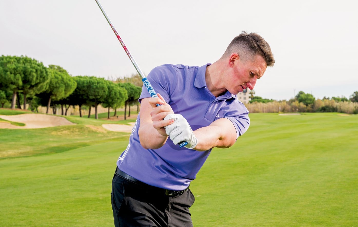 Gary Munro halfway back in the backswing, with the lead arm parallel to the ground and the lead wrist hinged