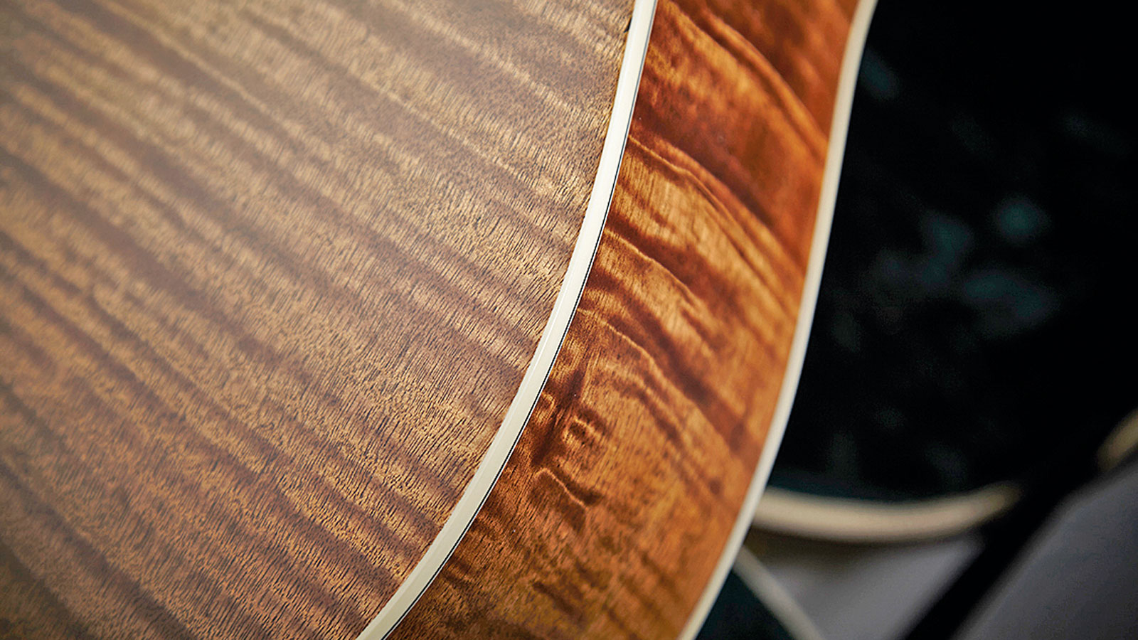 A stunning tiger mahogany veneer is used on the back and sides