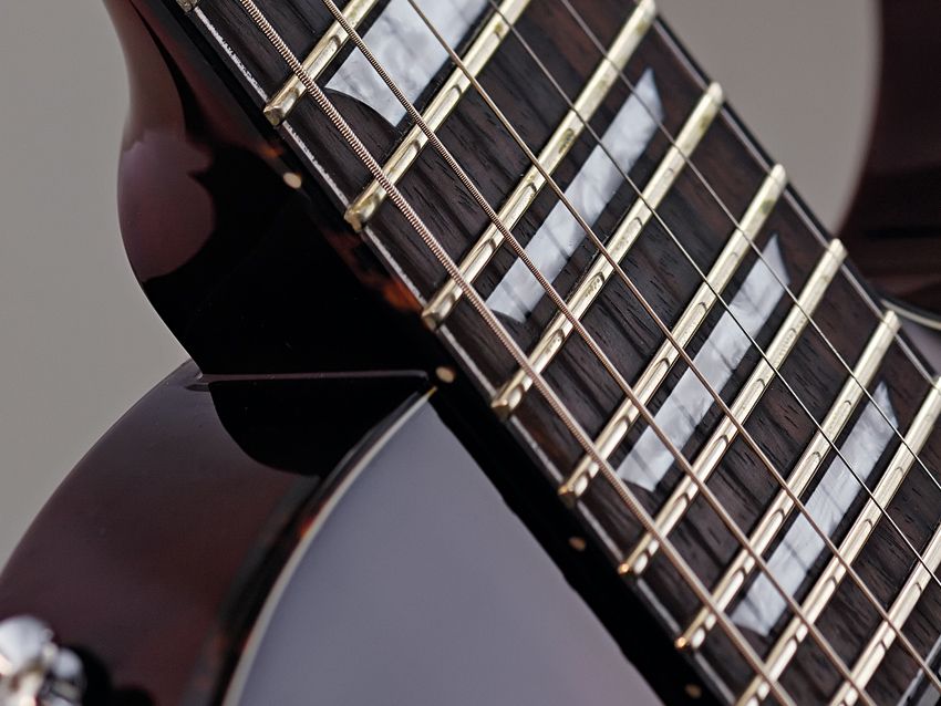 The Eclat Standard's medium jumbo frets are finely dressed.