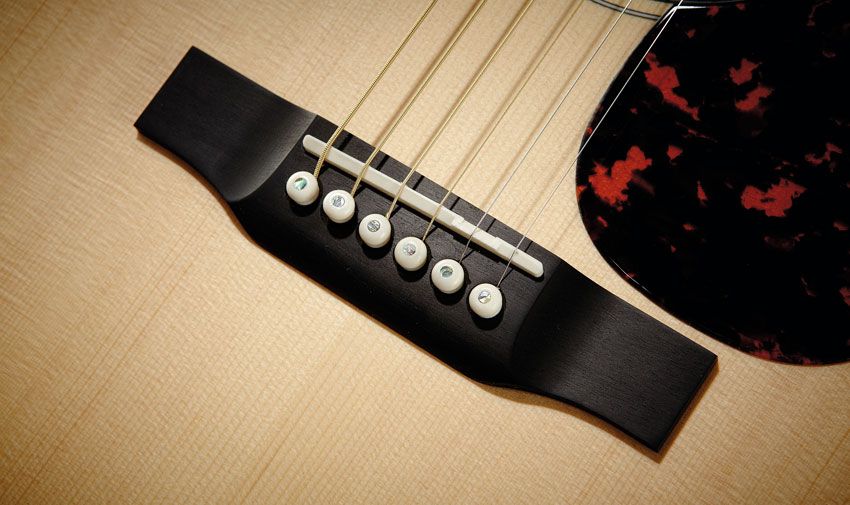 Ebony is used for the bridge, fingerboard and head facing