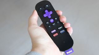 The Roku remote in someone's hand