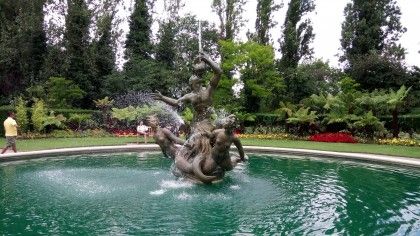 The water looks beautiful in this image and I'm impressed by the color from the flowers in the background.