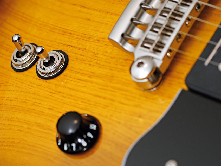 The two toggle switches unlock the tonal versatility of the CoAxe pickups.