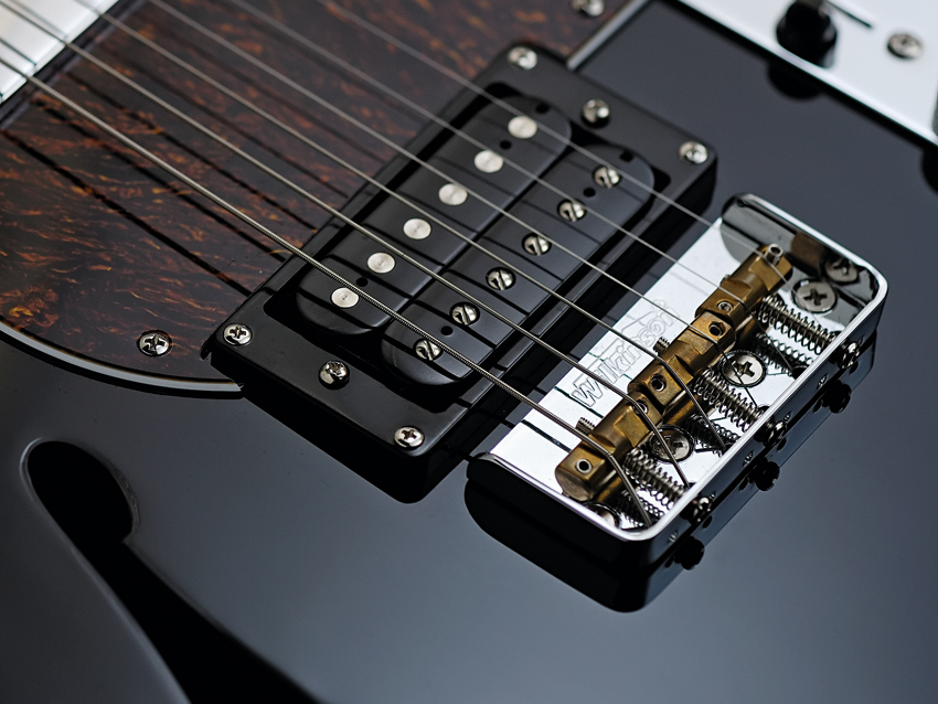 The Fret-King Country Squire Semitone&#039;s bridge has three compensated brass saddles.