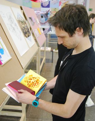 Computer Arts' Rich Carter flicking through Robert Cottrell's Shape+Colour publication at LCC's 2014 BA (Hons) Illustration and Visual Media degree show