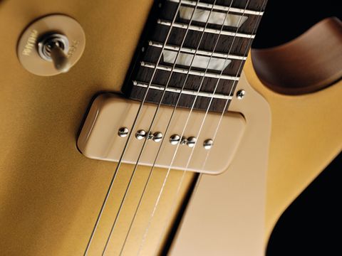 The worn gold of the Gibson suits its workhorse vibe.