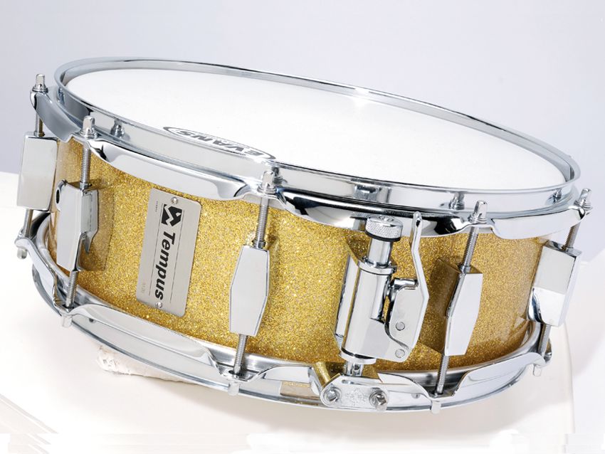 The inside of the gold fibreglass drum is translucent, while the other two are black with a honeycombed fabric