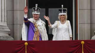 Charles and Camilla on the balcony on Coronation day watching the flypast
