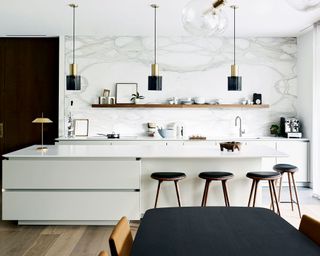 White kitchen ideas with pendants and stools