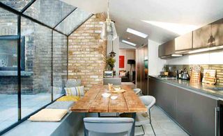 industrial style kitchen attached to period property with large glass extension