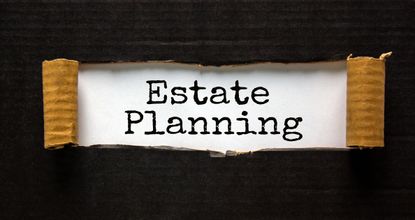 The text 'estate planning' appearing behind torn black paper. Business concept.