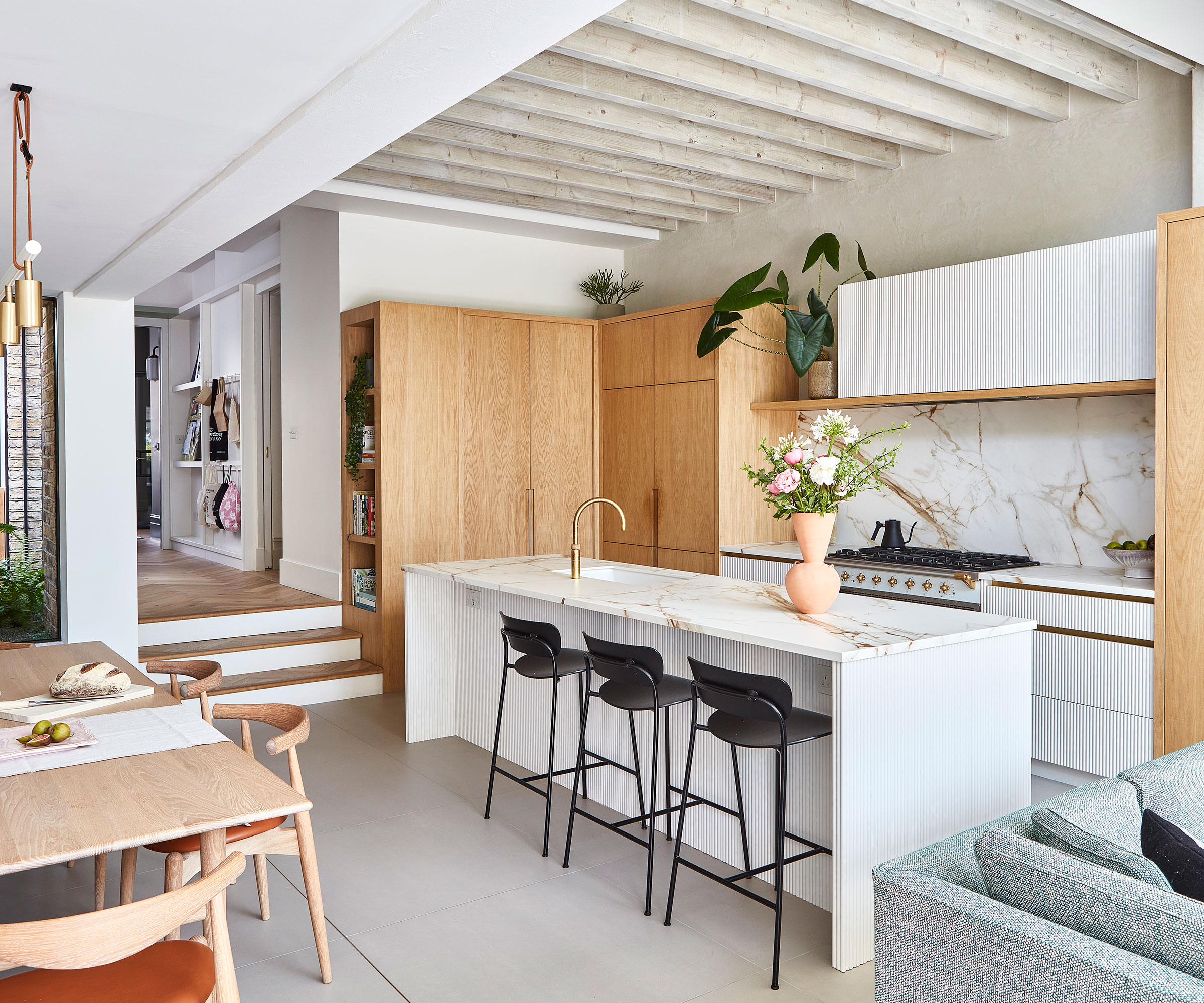 open-plan kitchen diner with wooden and marble finishes