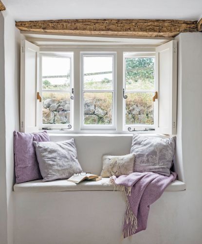 Deep window recess and window seat in a grade II listed thatched cottage