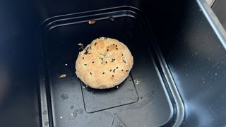 Air fryer bagel cooked and inside an air fryer