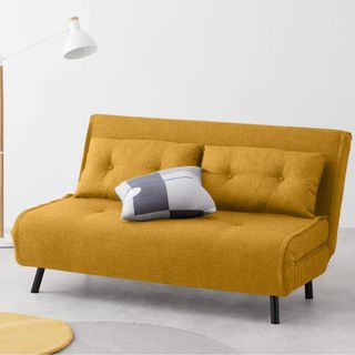 white room with butterscotch yellow sofa bed