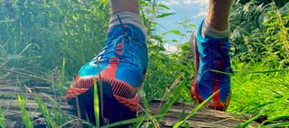 Man wearing Merrell Agility Peak 5 trail running shoes