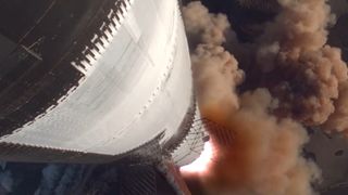 a silver rocket launches under blue skies