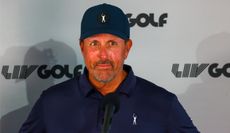 Mickelson answers questions in front of a LIV Golf board