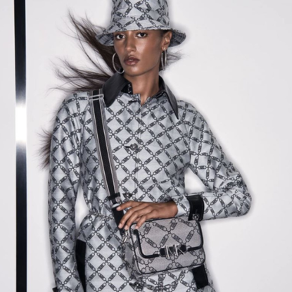 Woman wearing Michael Kors bag and hat