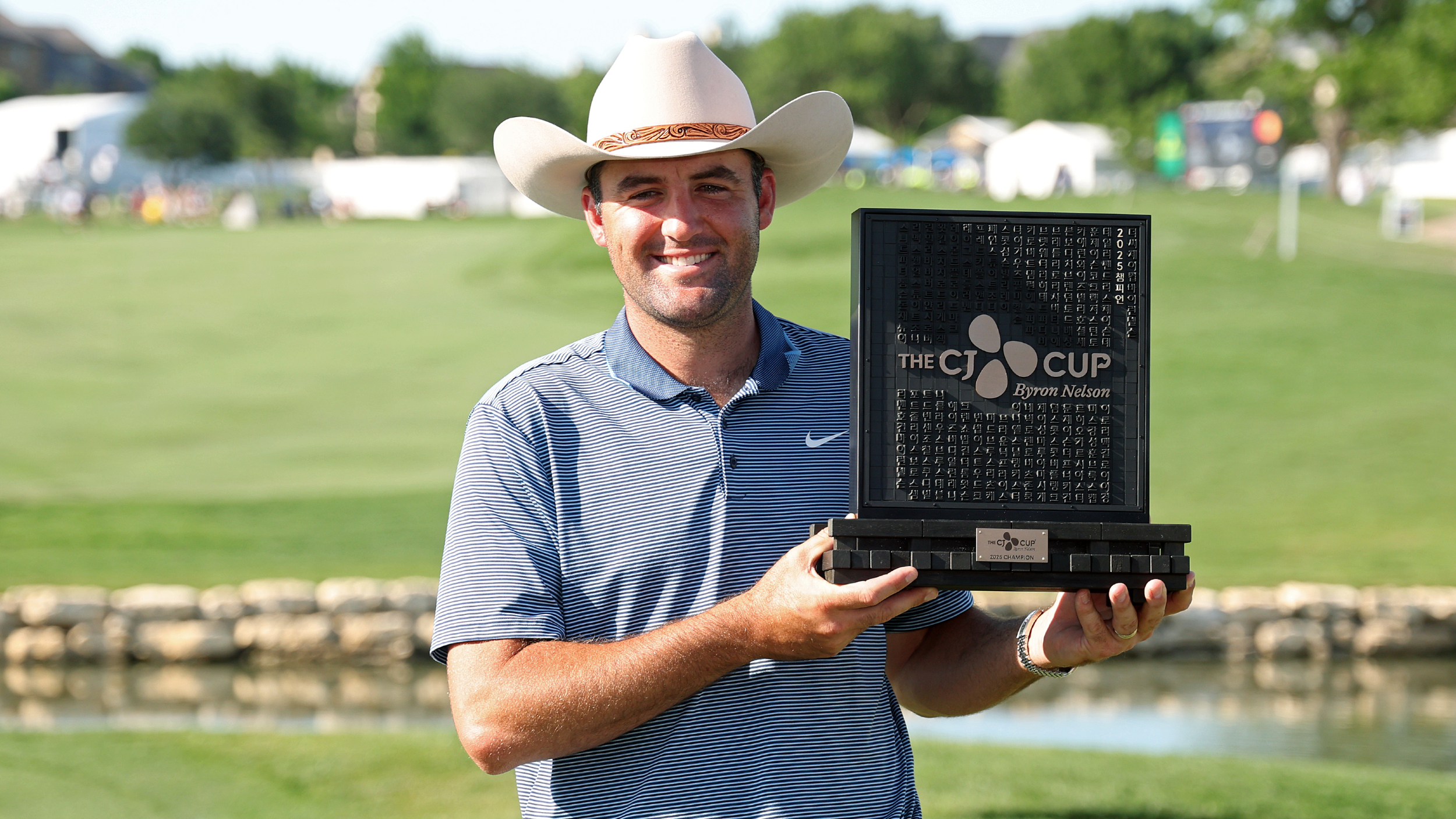 Scottie Scheffler poses for a photo with the CJ Cup Byron Nelson trophy