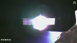 A space craft reflects light in the darkness of space