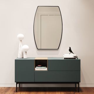  Luulake Metal Frame Wall Mirror hanging on a wall above a green blue storage cabinet
