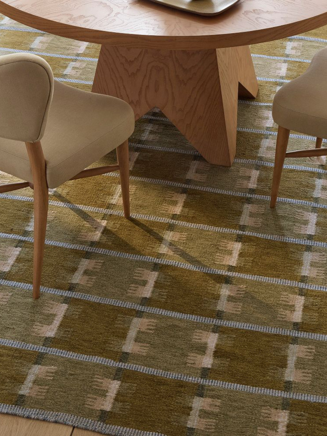 A patterned green rug from West Elm x Pierce &amp;amp; Ward