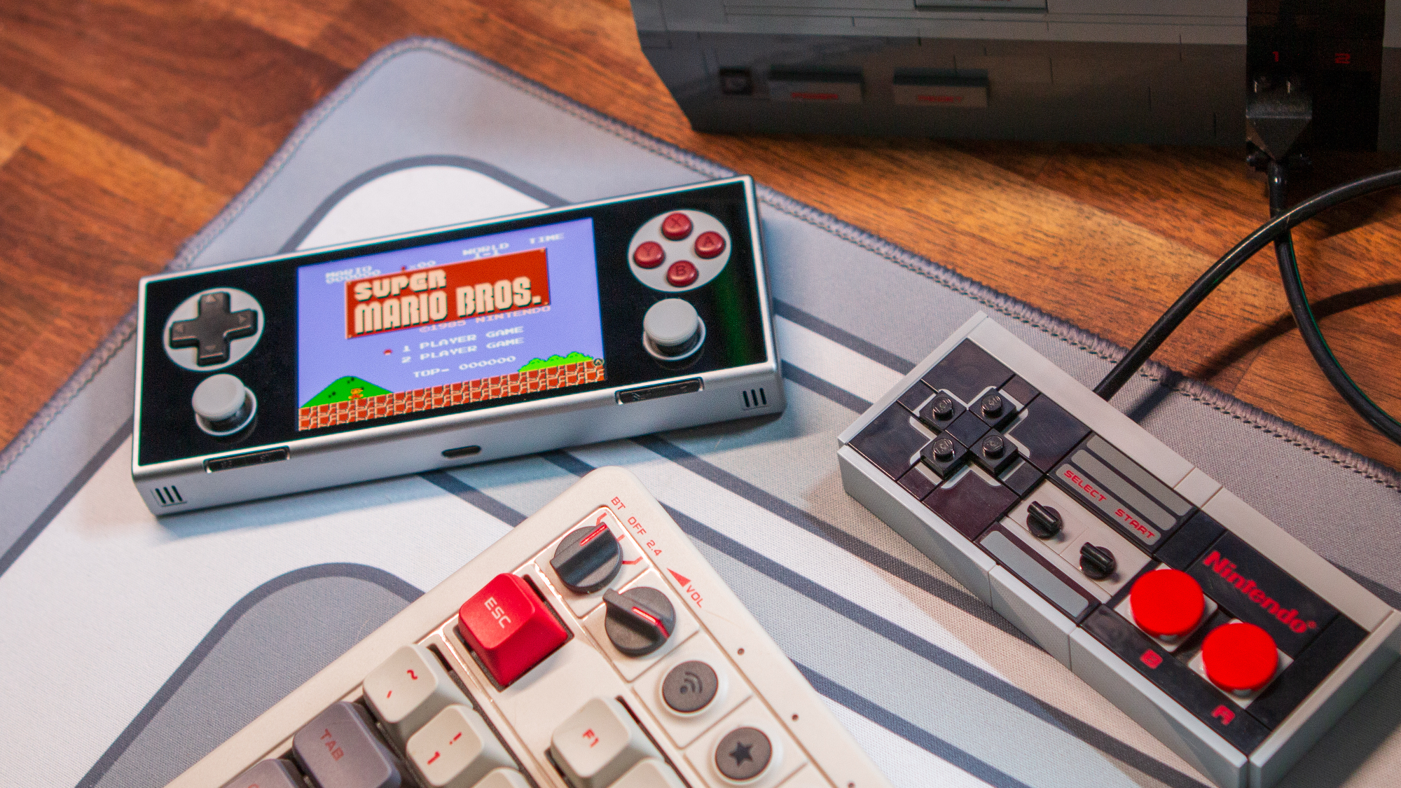 AYANEO Pocket Micro next to LEGO NES Controller playing Super Mario Bros.