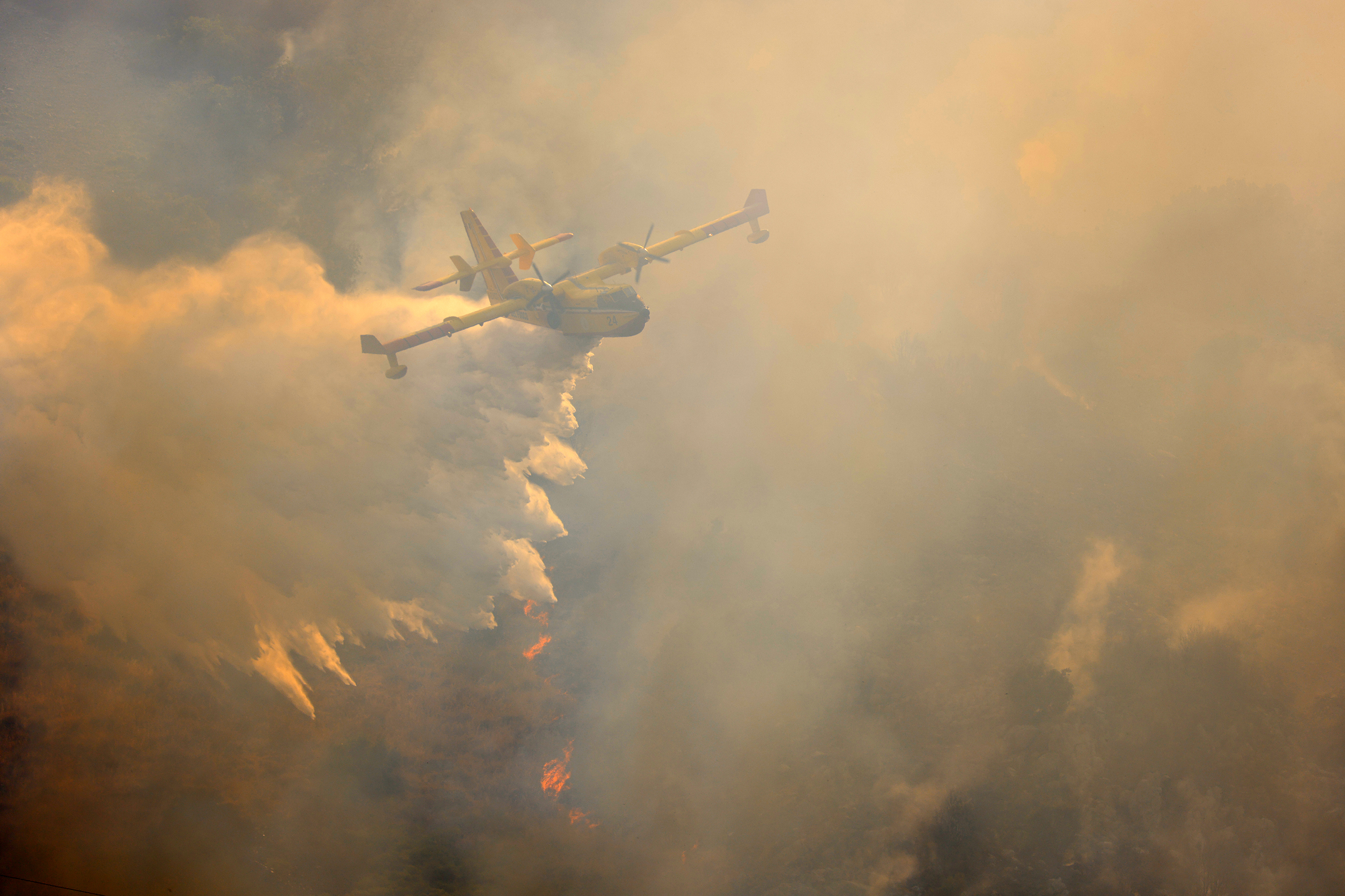 PALERMO, ITALY - JULY 15: Firefighters battle the fire with firefighting aircraft and helicopters in an effort to bring it under control as a wildfire that broke out in the maquis vegetation on the slopes of Mount Longa spreading rapidly due to strong winds near Palermo, Sicily, Italy, on July 15, 2026. (Photo by Alberto Lo Bianco/Anadolu via Getty Images)